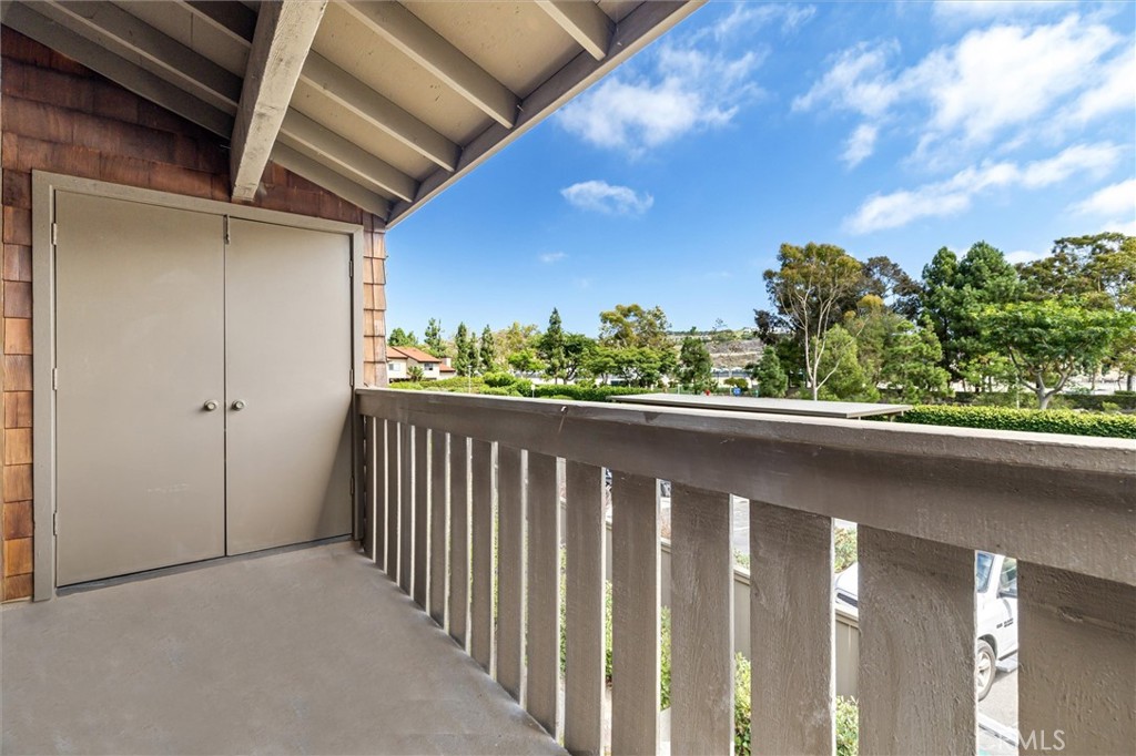 33852 Del Obispo Street, Unit 80 Dana Point, CA 92629 - Photo 15 of 36 a balcony with trees in the background