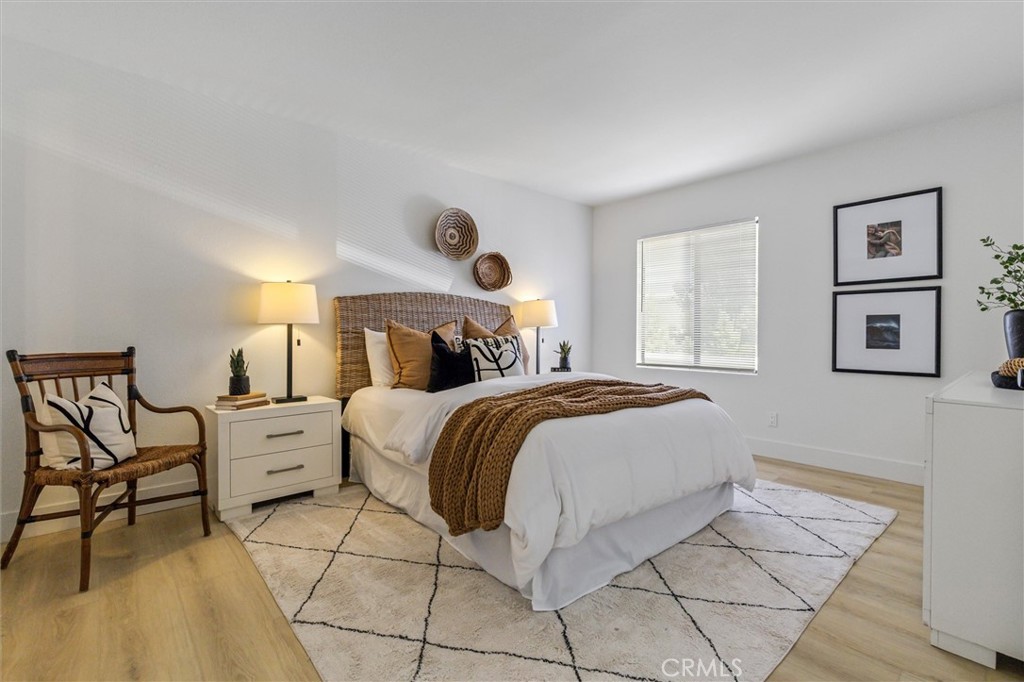 33852 Del Obispo Street, Unit 80 Dana Point, CA 92629 - Photo 20 of 36 a bedroom with a bed and a chair