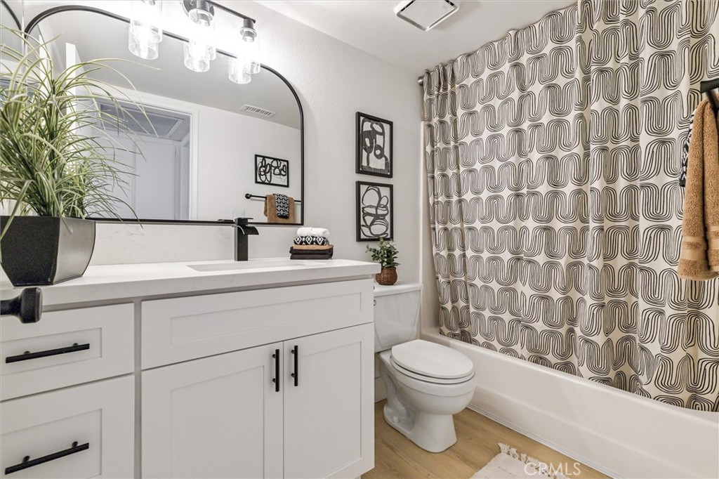 33852 Del Obispo Street, Unit 80 Dana Point, CA 92629 - Photo 25 of 36 a bathroom with a toilet a sink and mirror