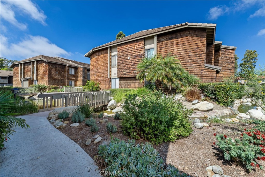 33852 Del Obispo Street, Unit 80 Dana Point, CA 92629 - Photo 26 of 36 a front view of a house with a yard