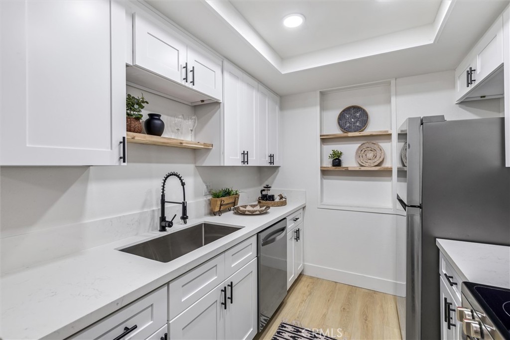 33852 Del Obispo Street, Unit 80 Dana Point, CA 92629 - Photo 5 of 36 a kitchen with a refrigerator and a sink