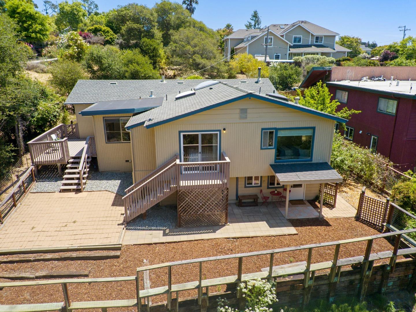 3407 Maplethorpe Lane Soquel, CA 95073 - Photo 48 of 52 a view of a white house with large windows and couches chairs