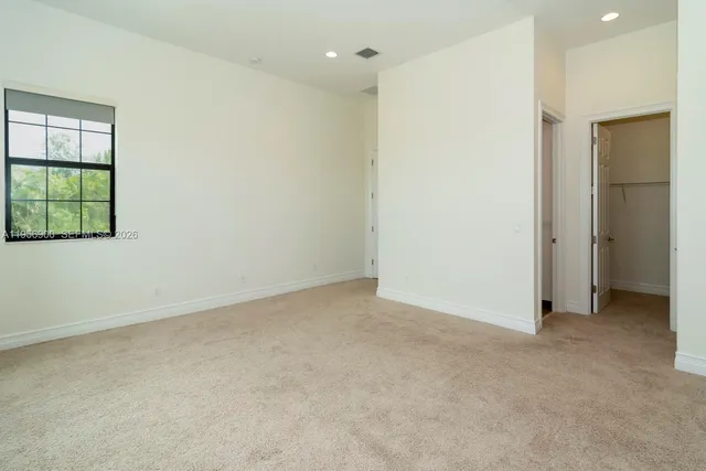 a bathroom with a granite countertop sink a mirror and a bathtub