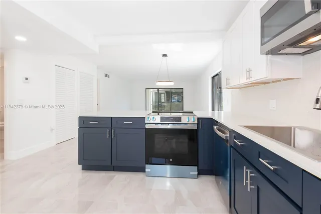 a kitchen with a sink and stainless steel appliances