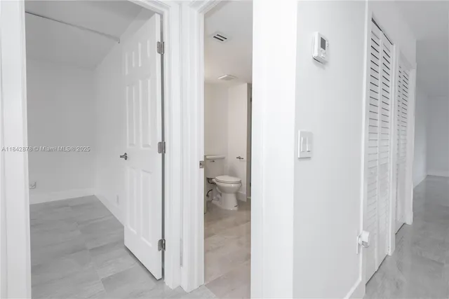 a view of a bathroom from a hallway
