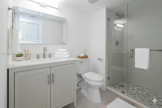 a bathroom with a sink toilet and shower