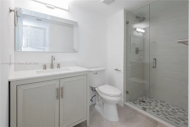 a bathroom with a sink toilet and shower