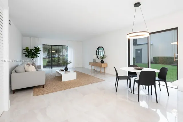 a dining room with furniture a chandelier and wooden floor