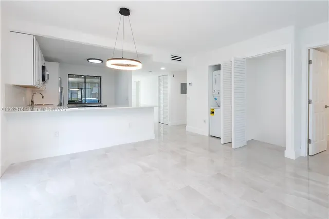 a view of a kitchen with a sink and dishwasher cabinets