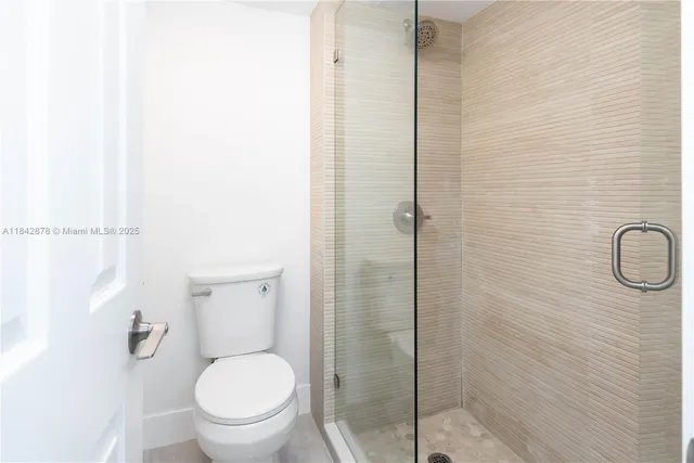 a white toilet sitting next to a bathroom sink