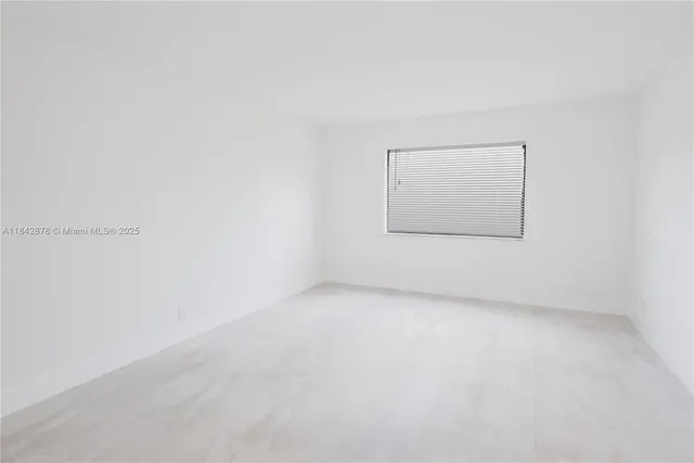 an empty room with a empty space and mirror