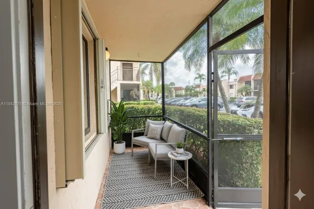 a balcony view with a large window and wooden floor