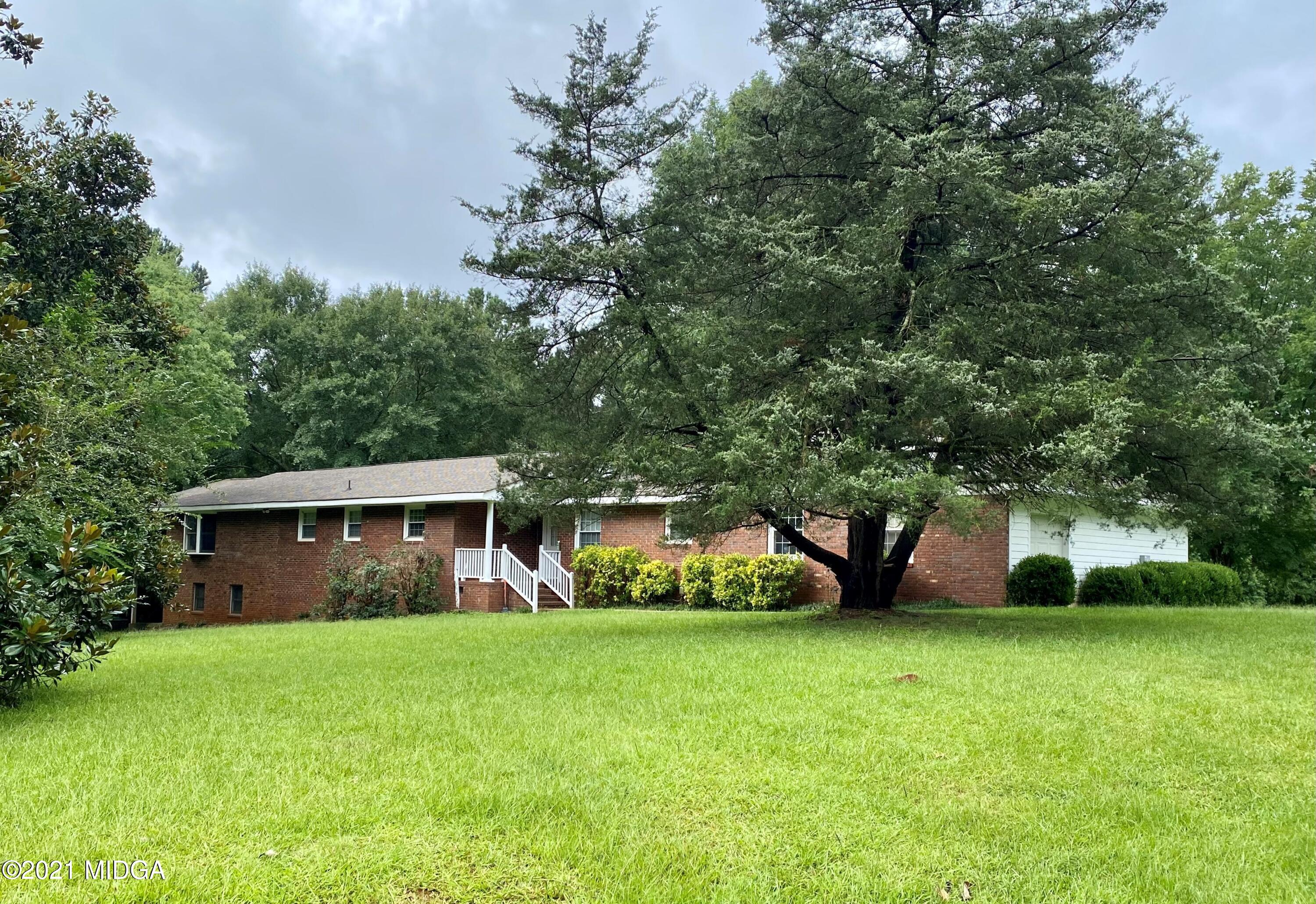 1321 Charles Johnson Road Forsyth, GA 31029 - Photo 1 of 1 a front view of house with garden