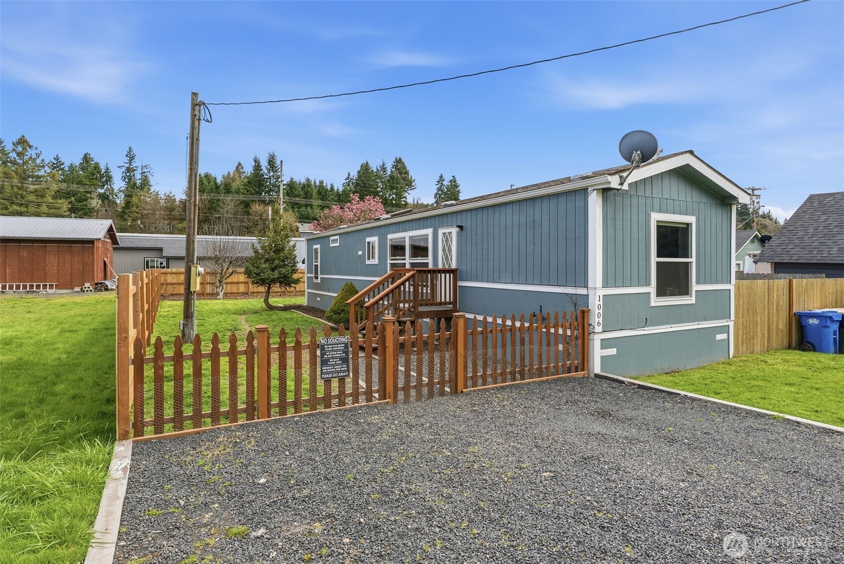 a view of a house with wooden fence