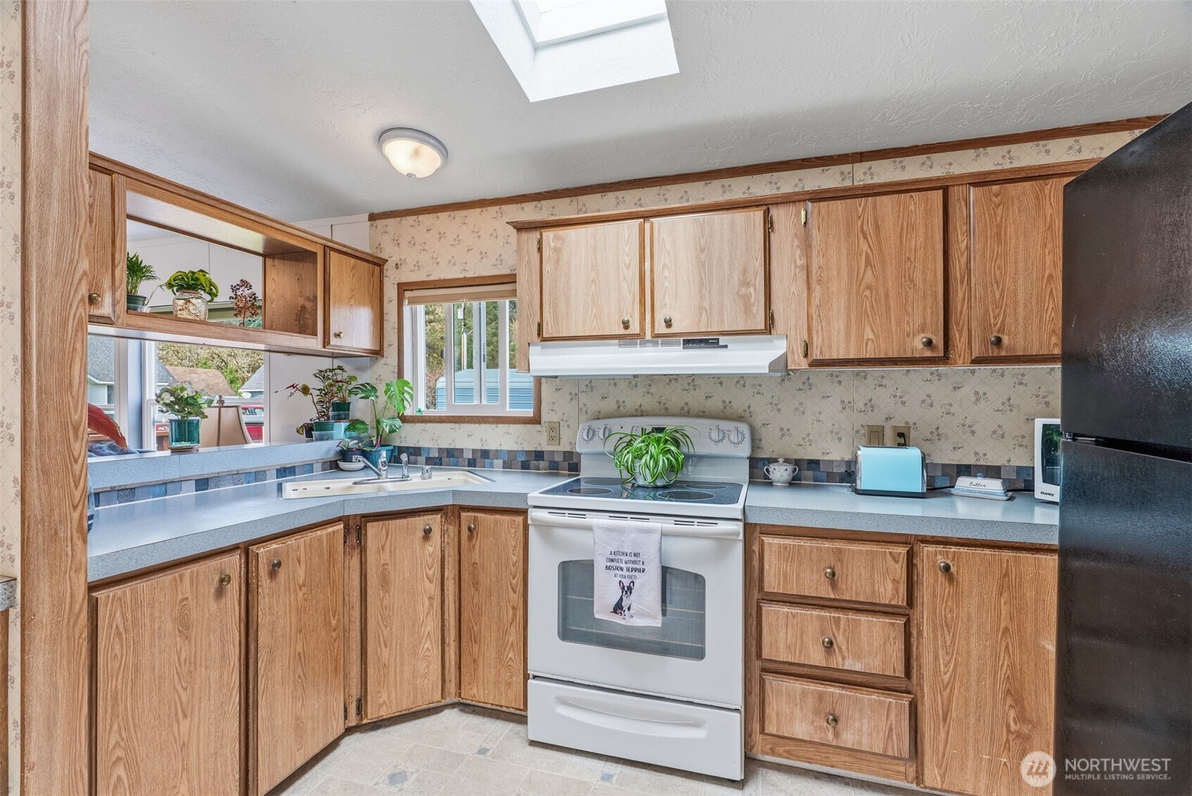 1006 Northwest Mill Street Winlock, WA 98596 - Photo 17 of 22 a kitchen with stainless steel appliances granite countertop a sink and cabinets