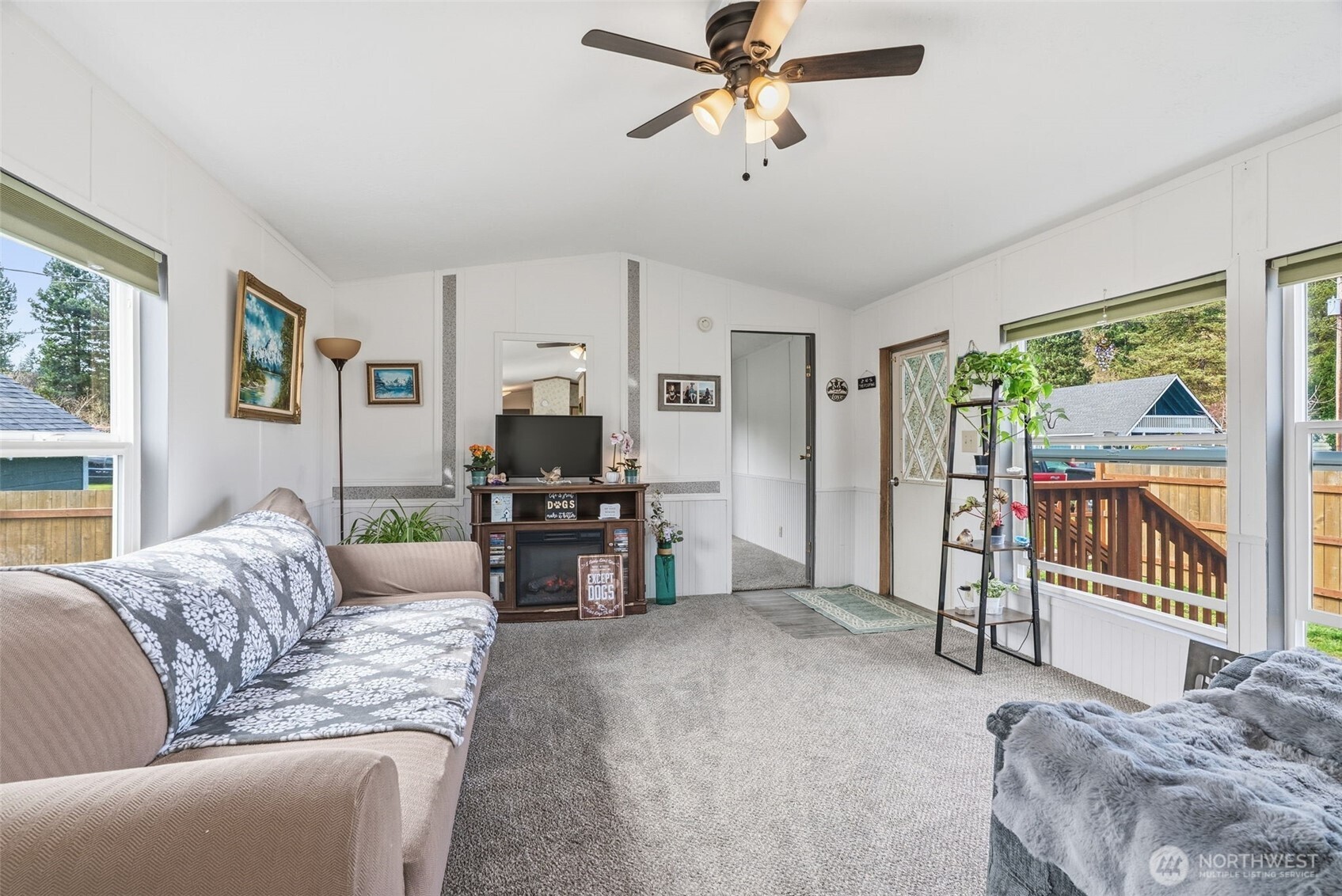 1006 Northwest Mill Street Winlock, WA 98596 - Photo 8 of 22 a living room with furniture a ceiling fan and a flat screen tv