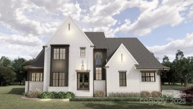 a view of a white house next to a yard