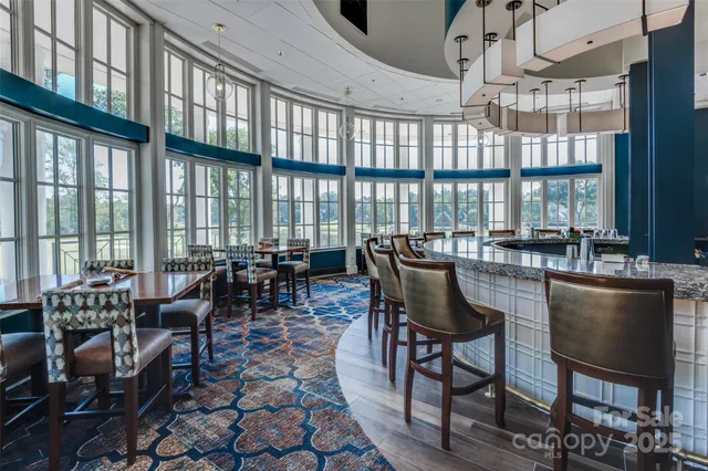 a dining room with furniture a chandelier and wooden floor