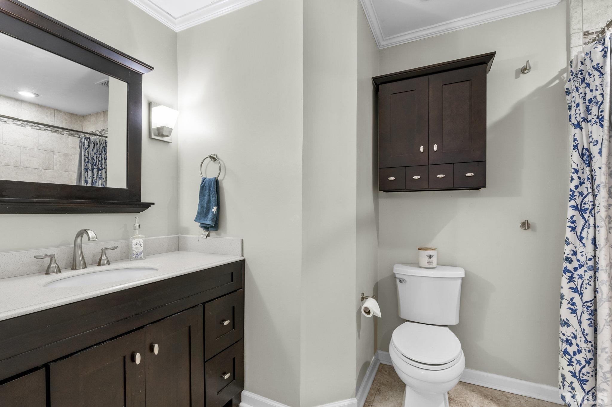 5666 Hamstead Crossing Raleigh, NC 27612 - Photo 8 of 32 a bathroom with a toilet a sink and mirror
