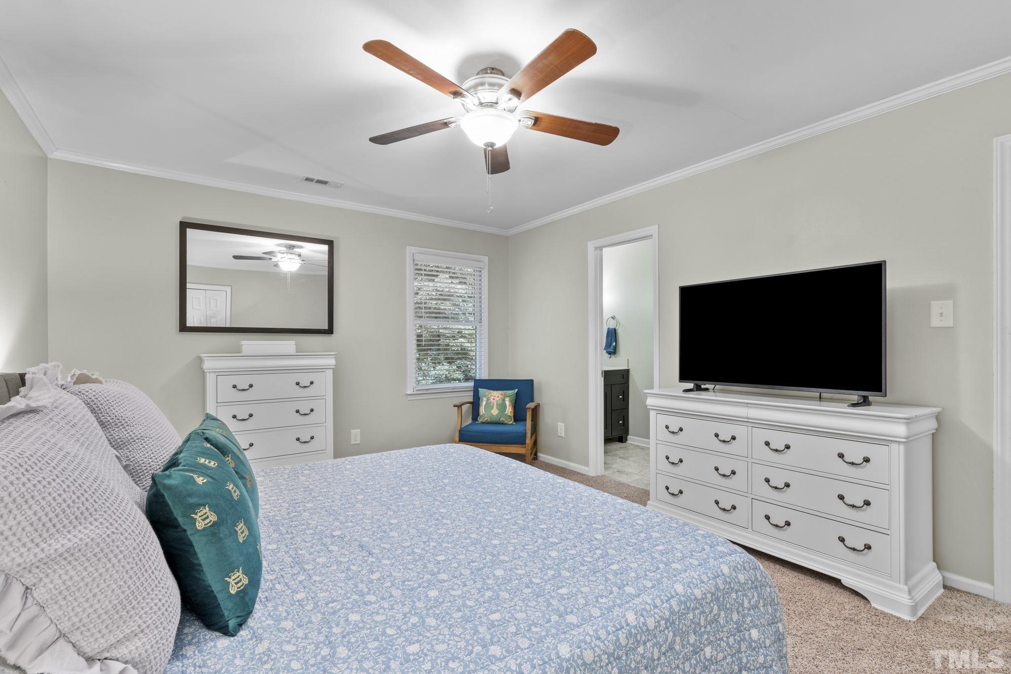 5666 Hamstead Crossing Raleigh, NC 27612 - Photo 10 of 32 a bedroom with a bed and a flat screen tv