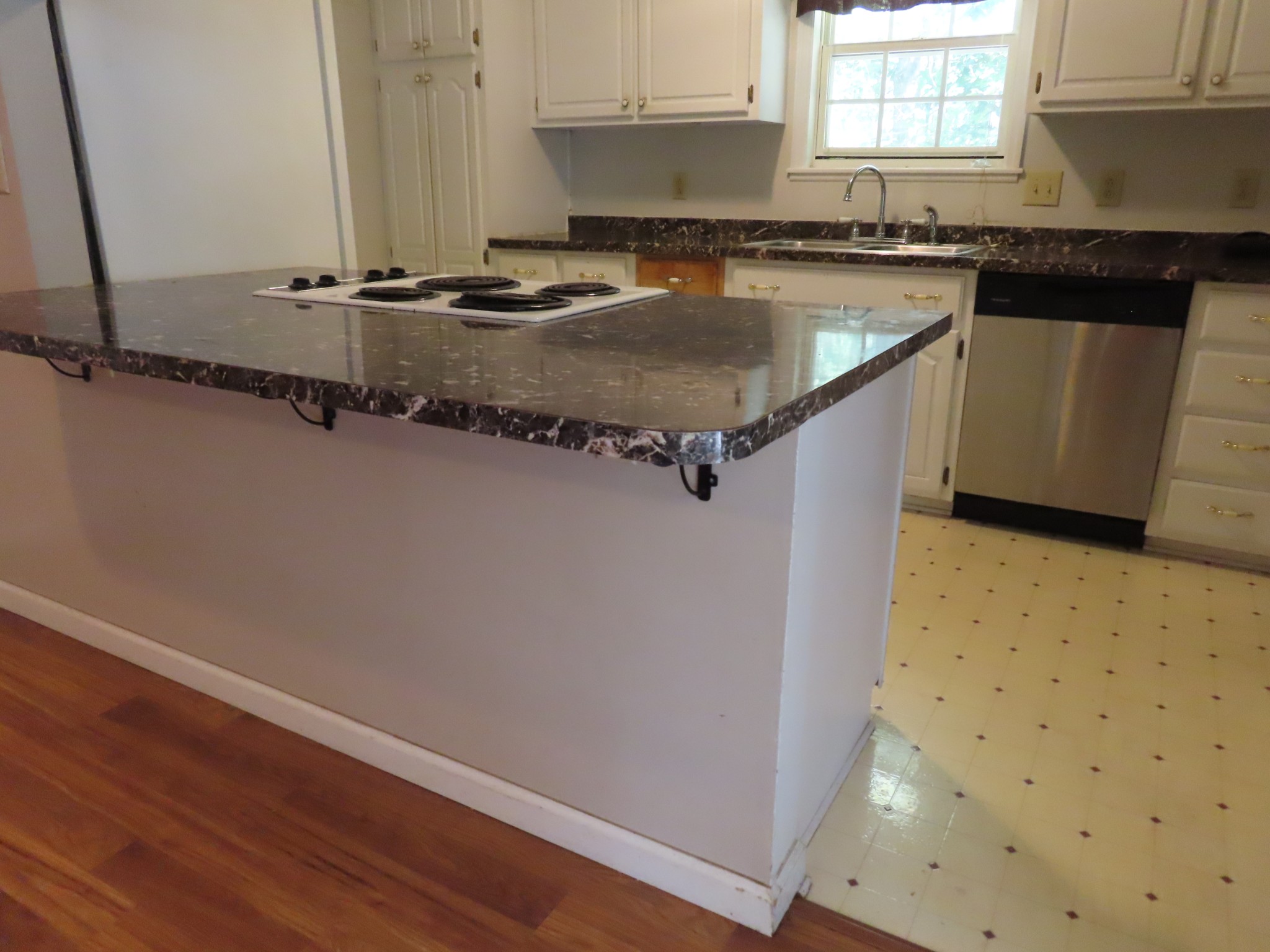 511 Bumpas Road Lawrenceburg, TN 38464 - Photo 7 of 14 a kitchen with a sink a refrigerator and wooden floor