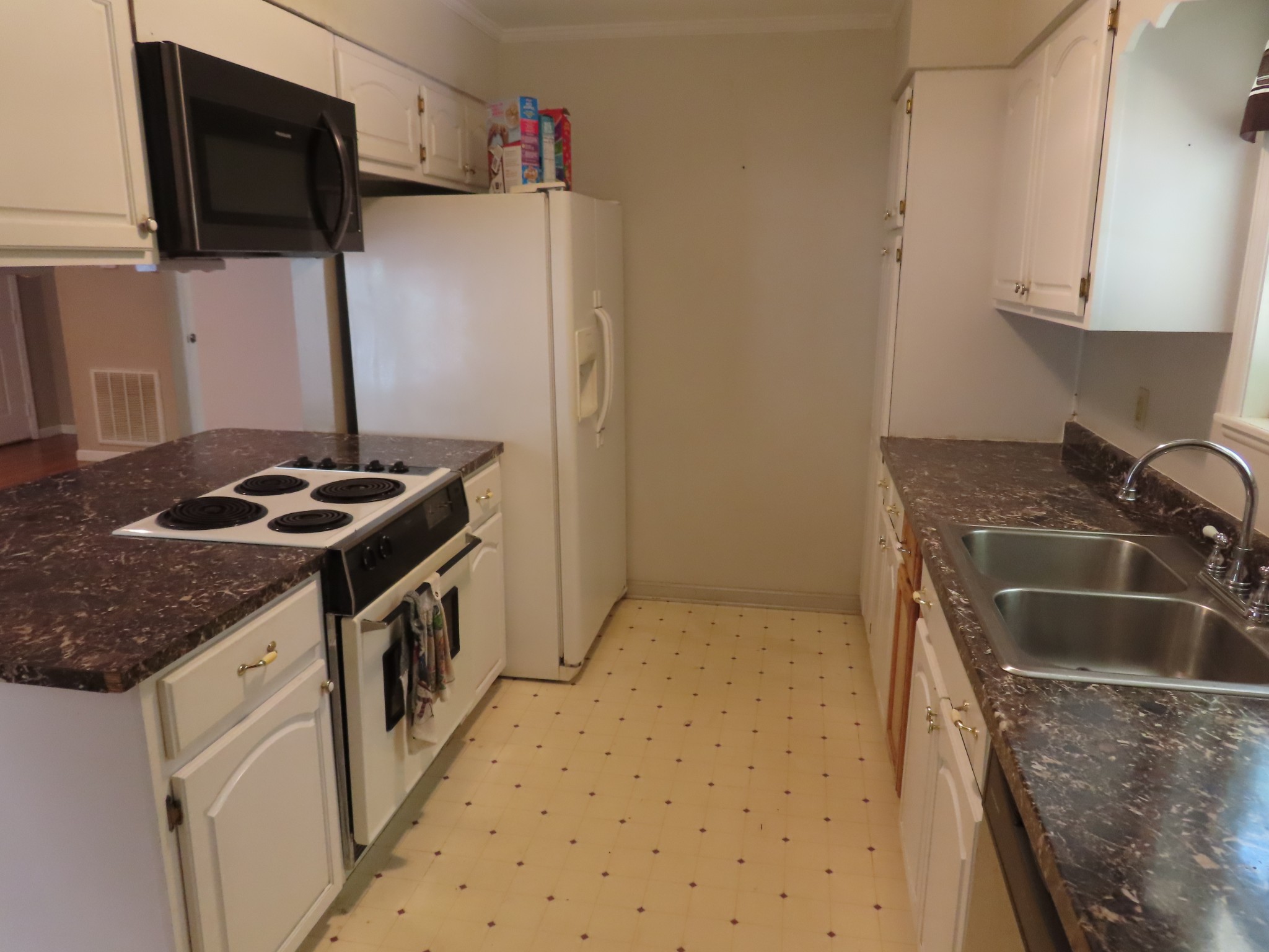 511 Bumpas Road Lawrenceburg, TN 38464 - Photo 8 of 14 a kitchen with granite countertop a sink stove and microwave