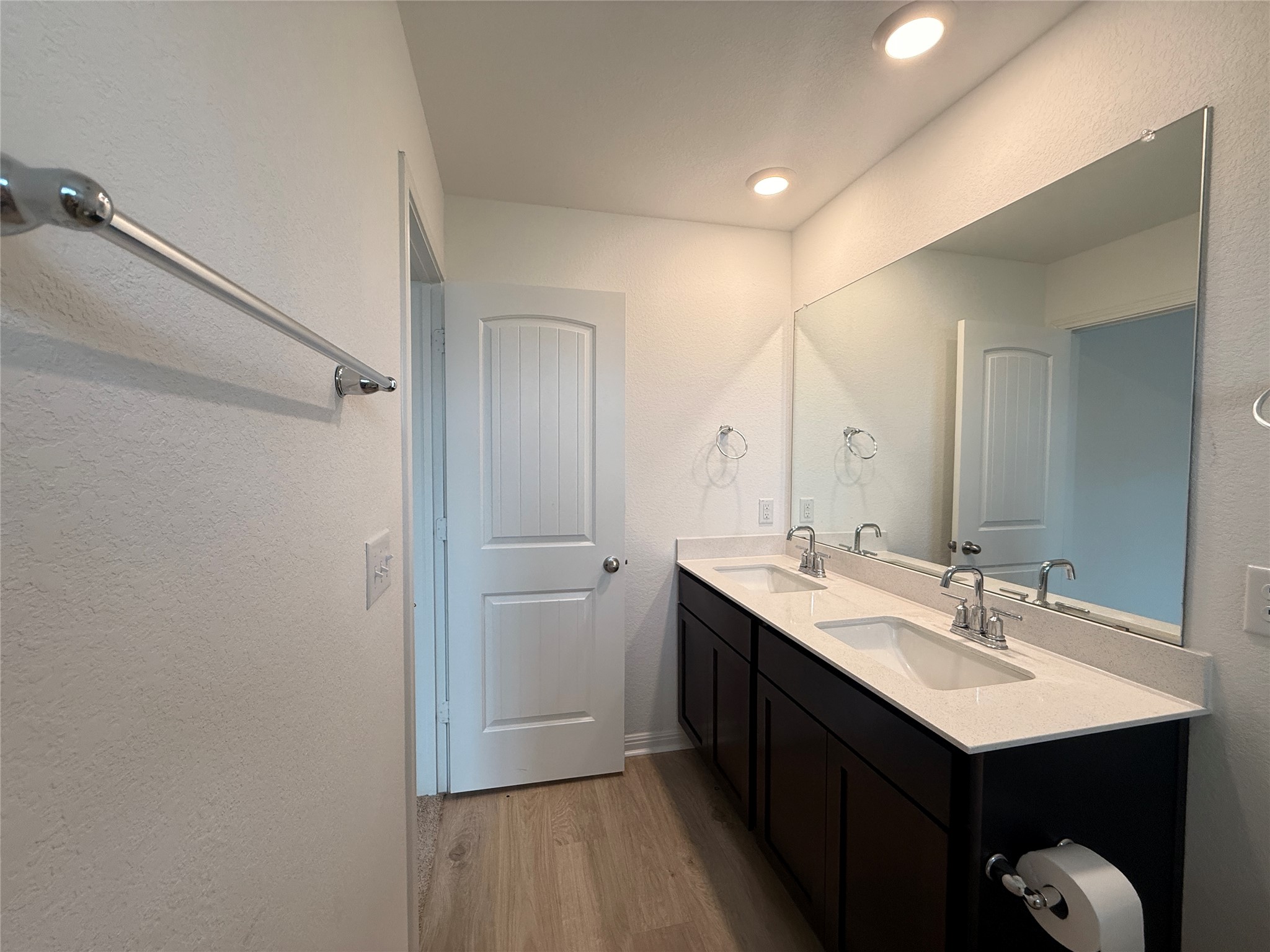 120 Calla Lane Georgetown, TX 78626 - Photo 11 of 19 Bathroom with a textured wall, double vanity, and light wood finished floors