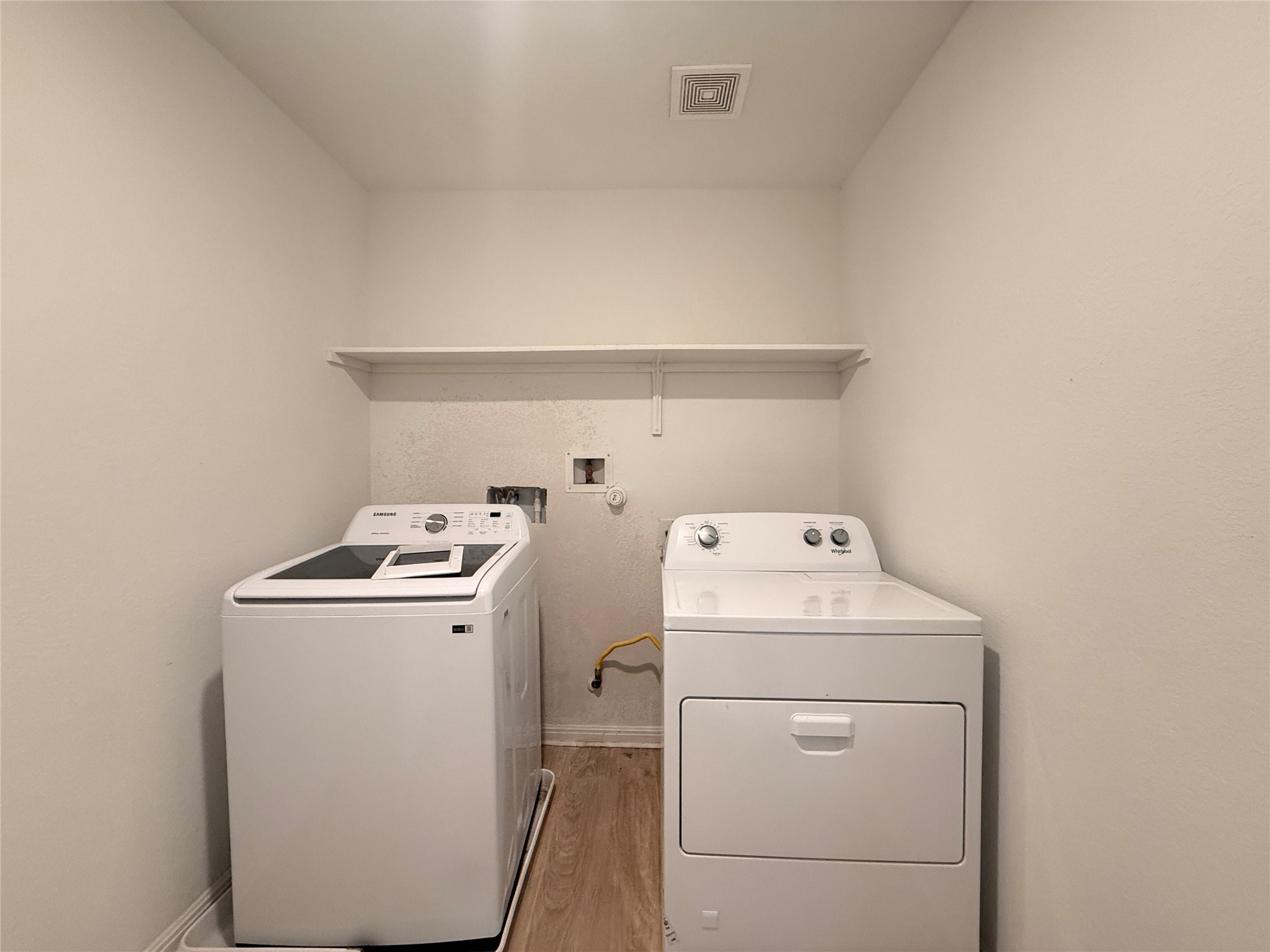 120 Calla Lane Georgetown, TX 78626 - Photo 18 of 19 Laundry room with light wood-type flooring and independent washer and dryer