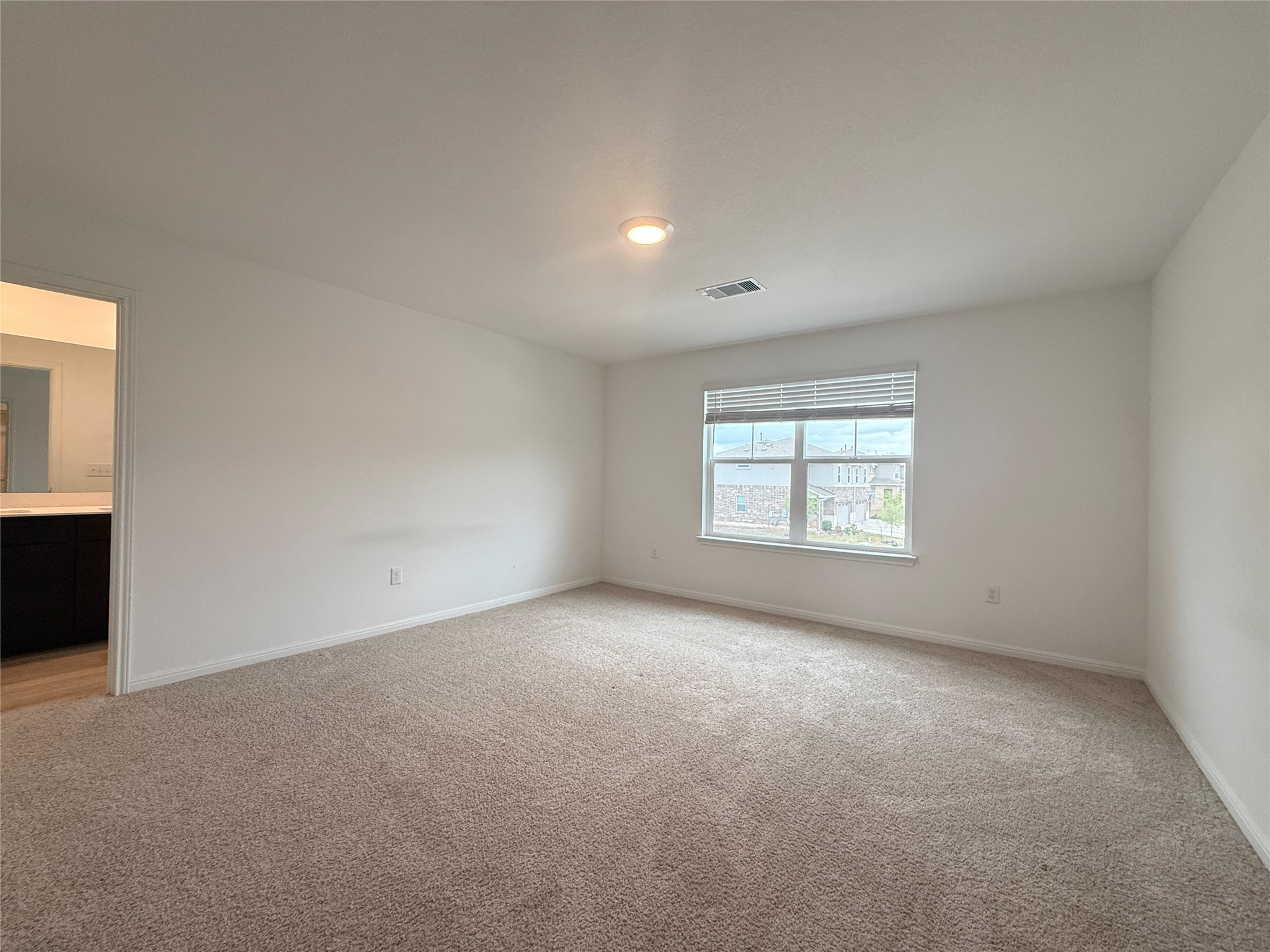 120 Calla Lane Georgetown, TX 78626 - Photo 7 of 19 Empty room with baseboards and light carpet