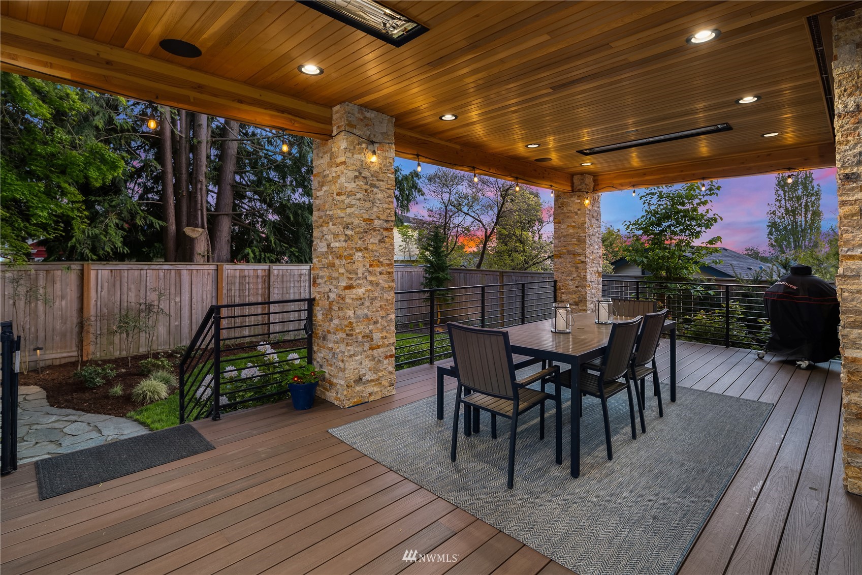 111 North 76th Street Seattle, WA 98103 - Photo 11 of 40 a patio with wooden floor a yard a table and chairs