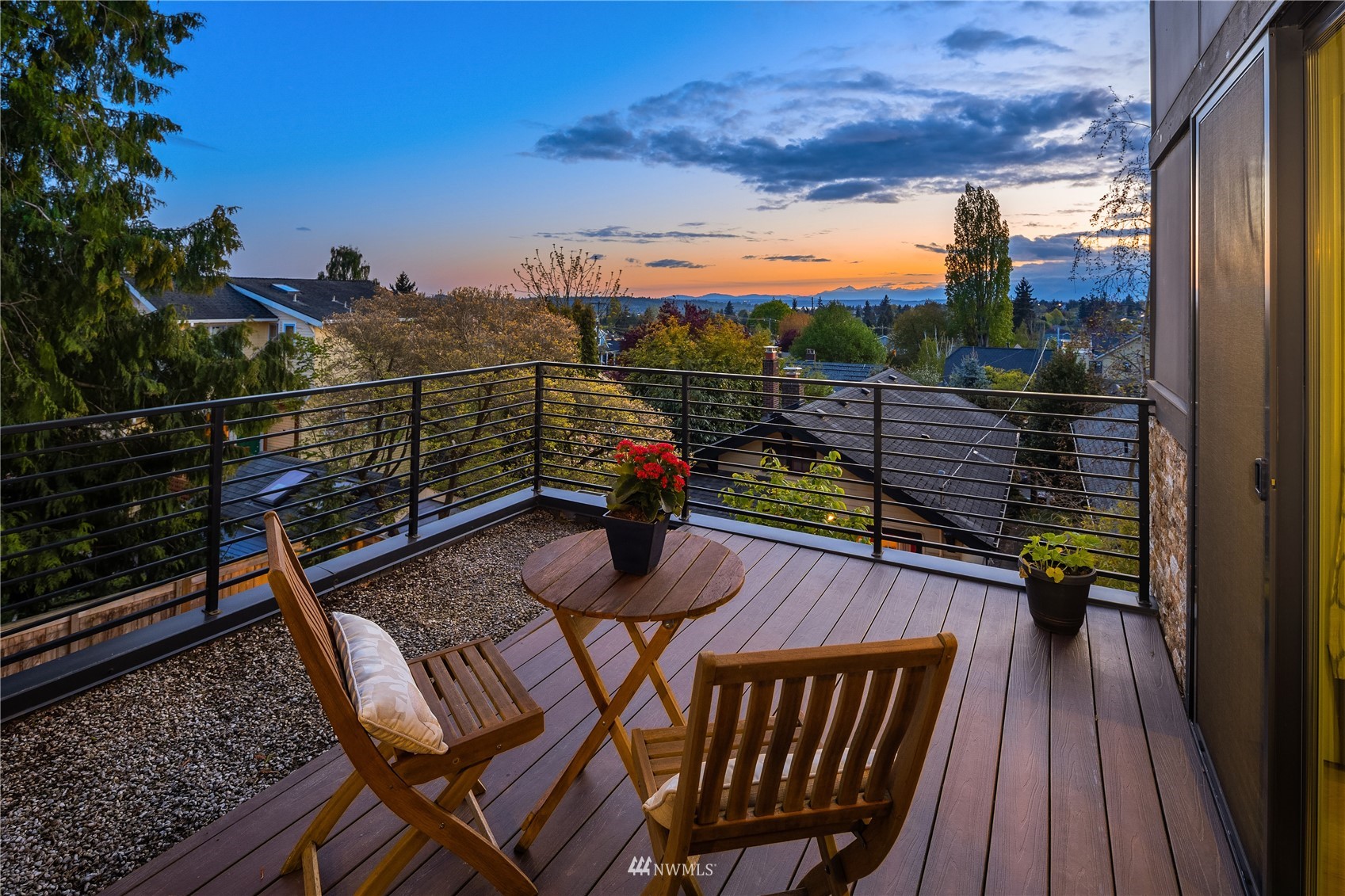 111 North 76th Street Seattle, WA 98103 - Photo 21 of 40 a view of a balcony with two chairs and a potted plant