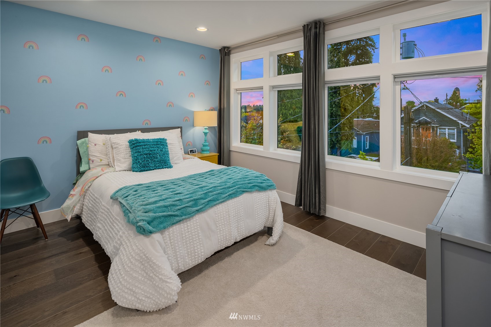 111 North 76th Street Seattle, WA 98103 - Photo 25 of 40 a bed sitting in a bedroom next to a large window