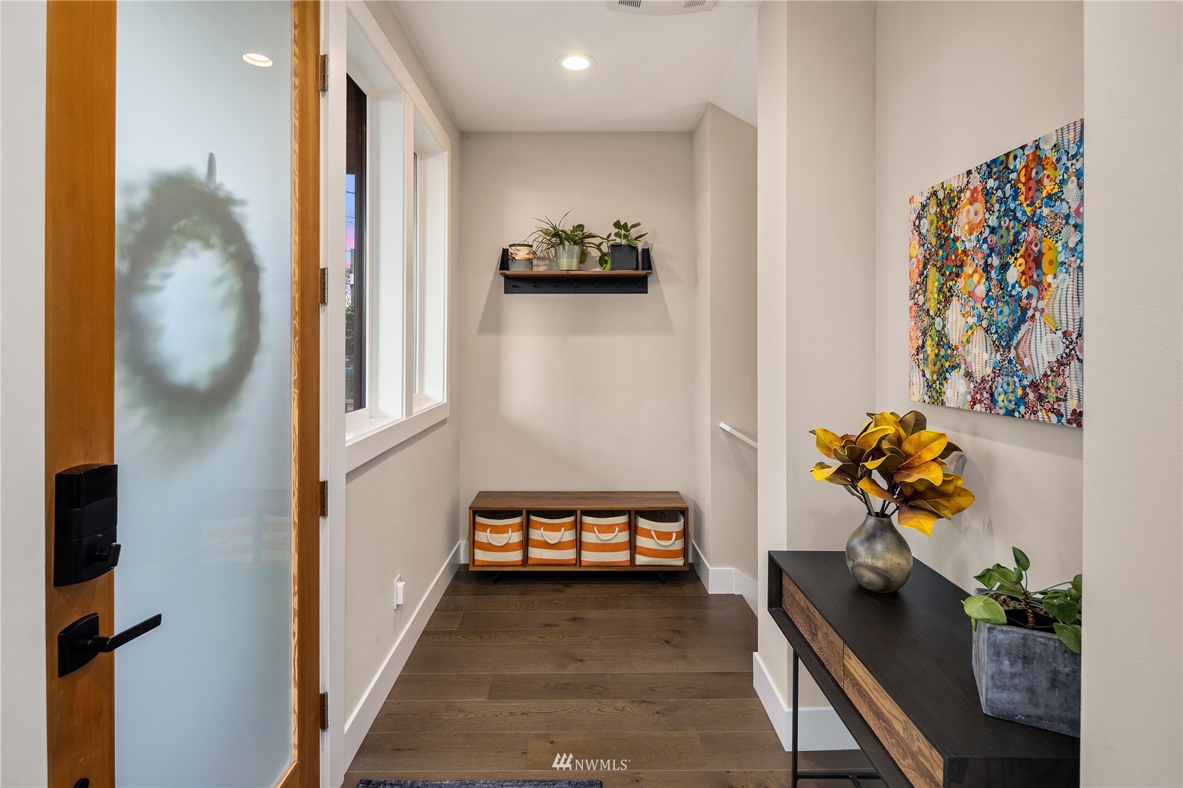 111 North 76th Street Seattle, WA 98103 - Photo 3 of 40 a hallway with painting on the wall and a potted plant