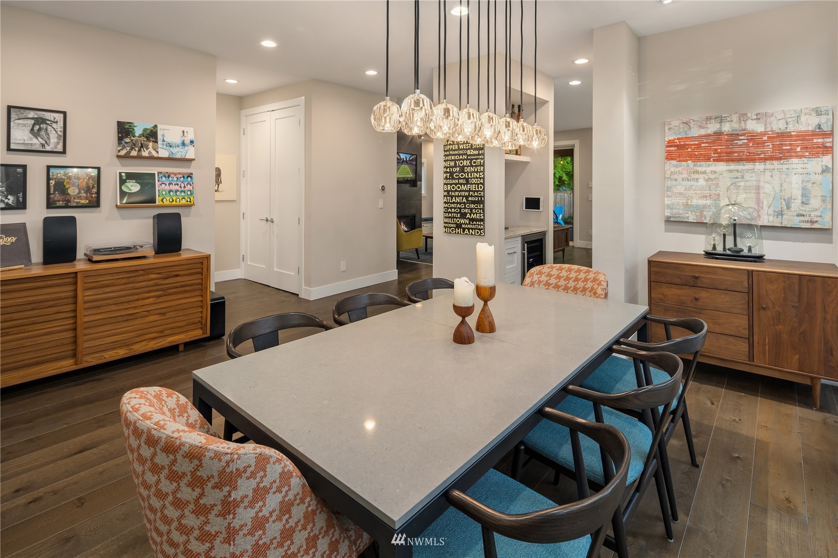 111 North 76th Street Seattle, WA 98103 - Photo 5 of 40 a living room with furniture a chandelier and a dining table