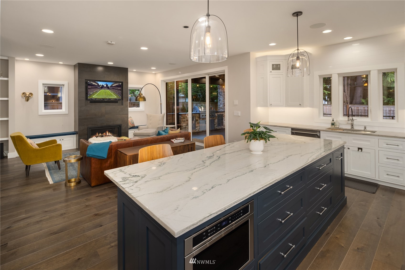 111 North 76th Street Seattle, WA 98103 - Photo 8 of 40 a kitchen with a dining table chairs sink and wooden floor