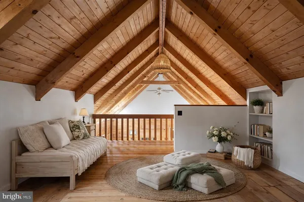 a bedroom with furniture and a wooden floor