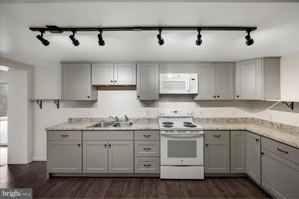 a kitchen with stainless steel appliances granite countertop a sink and cabinets