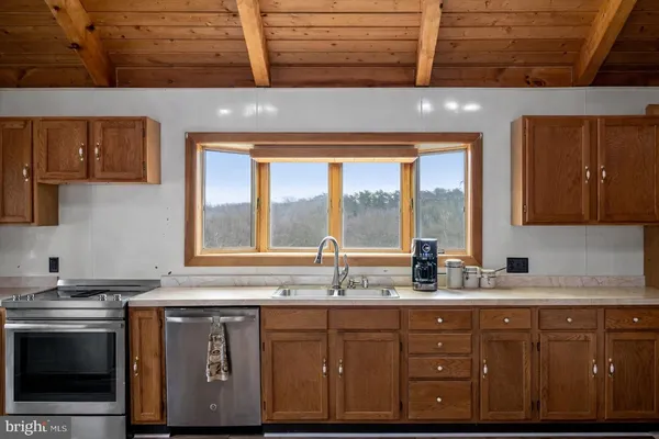 a kitchen with granite countertop cabinets stainless steel appliances and a sink