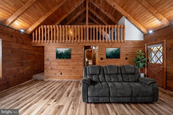 a view of a house with couches and wooden floor