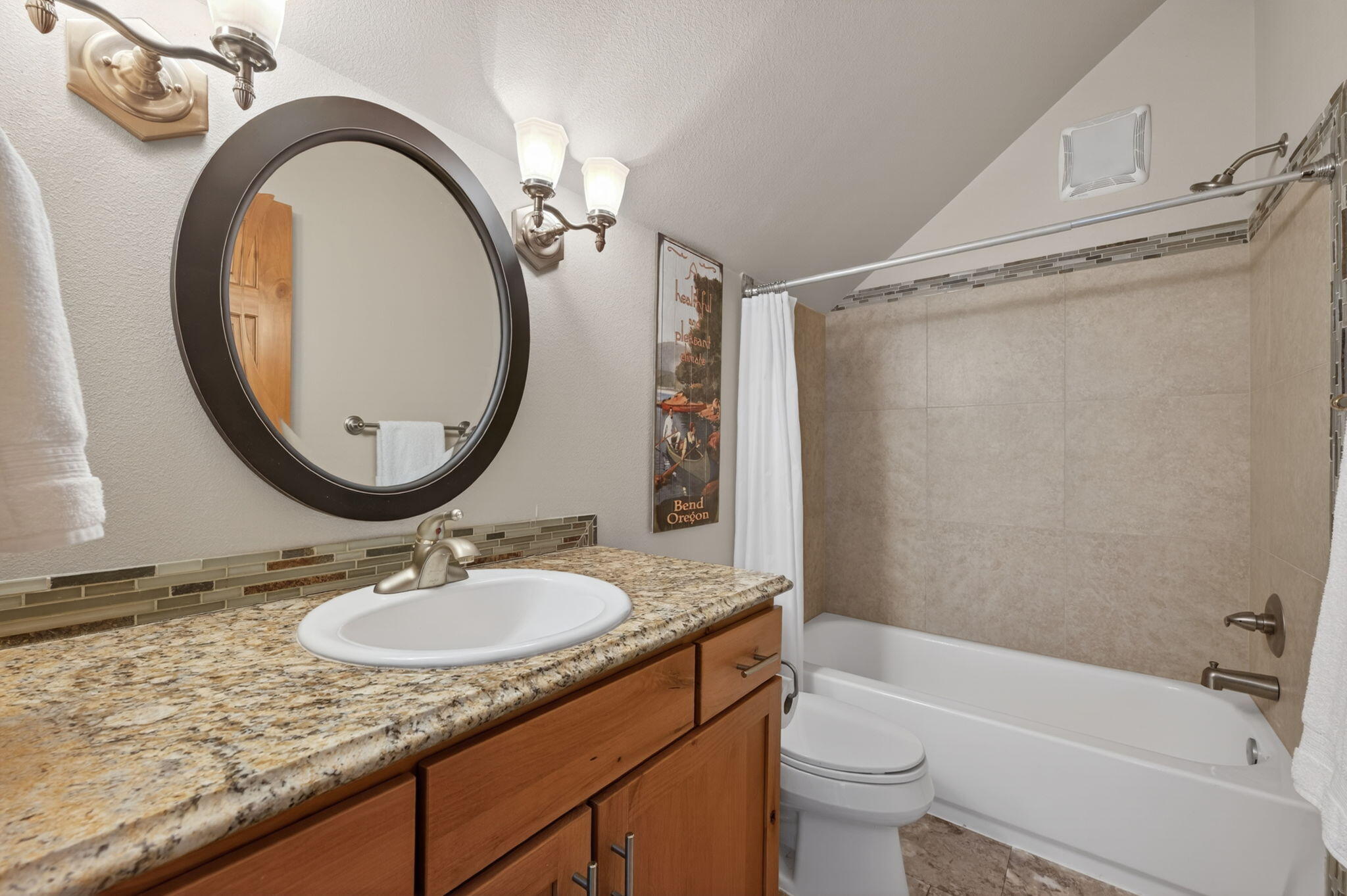 20180 Winston Loop Bend, OR 97703 - Photo 44 of 59 a bathroom with a granite countertop sink toilet mirror vanity and bathtub