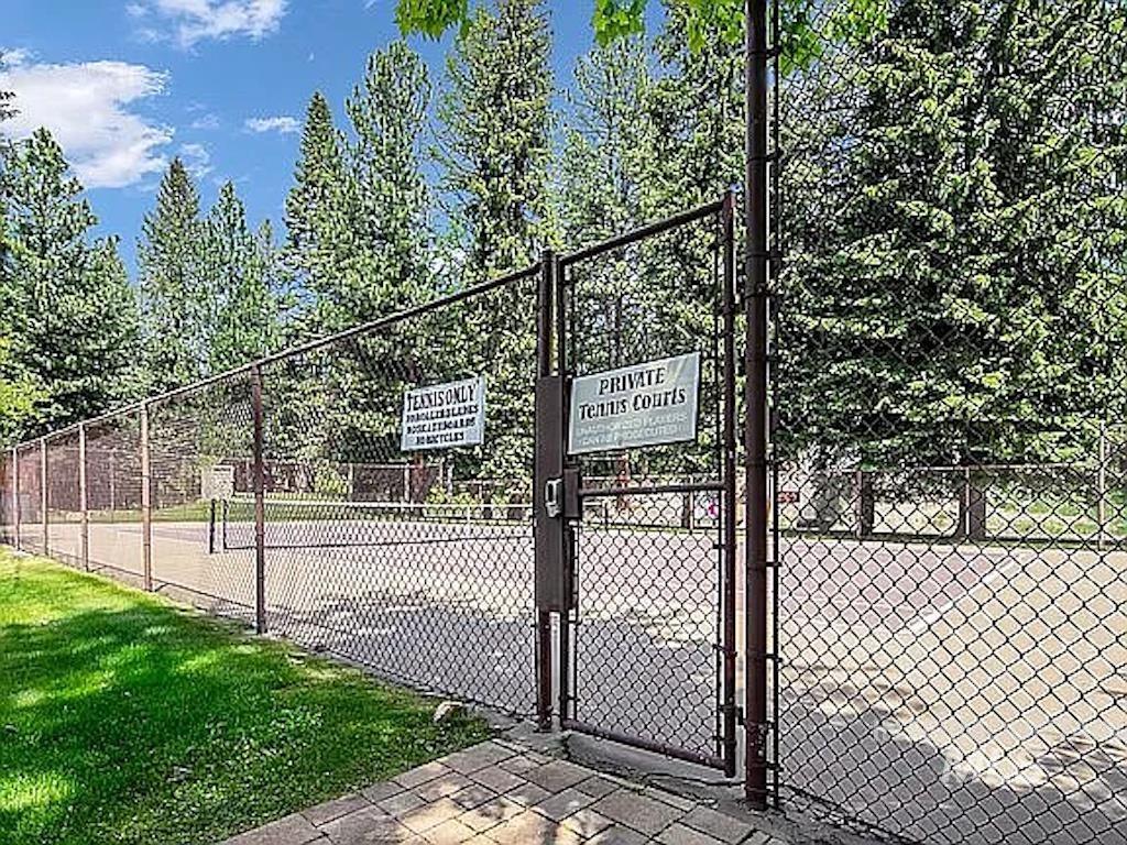 302 Mather Road, Unit C3 McCall, ID 83638 - Photo 12 of 12 Fenced private tennis courts with surrounding mature trees and a paved entryway