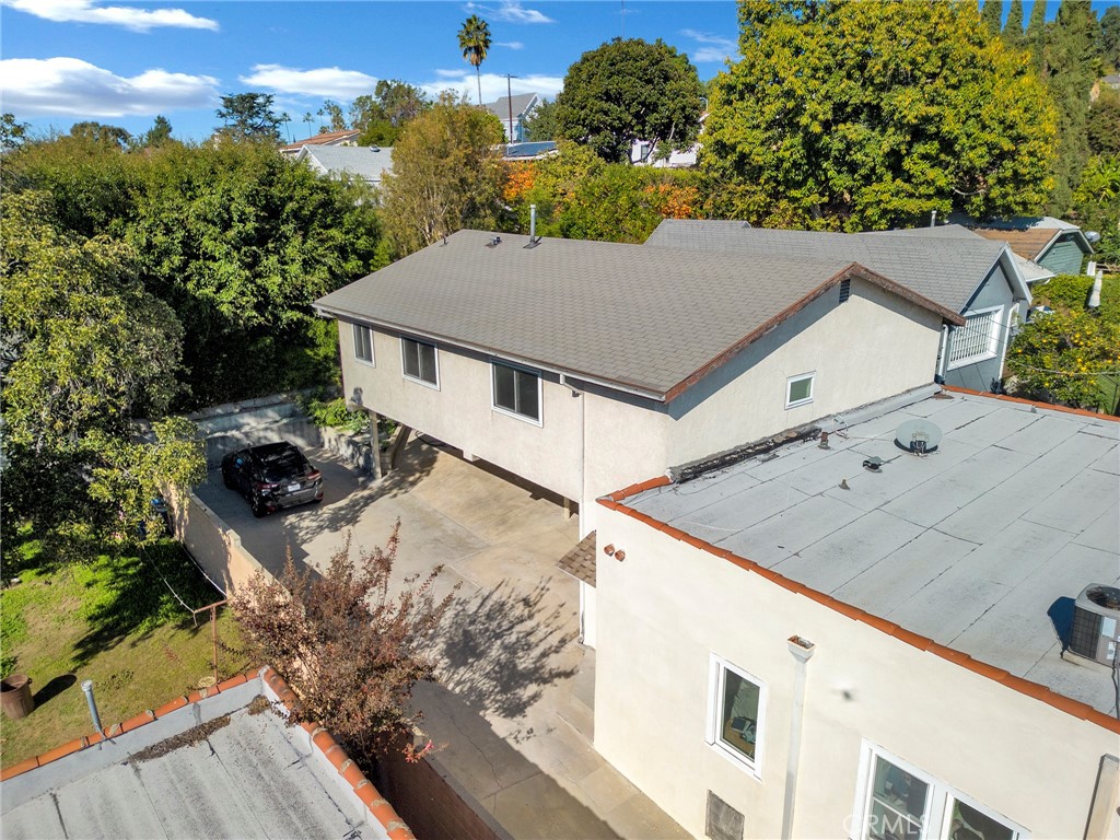 727 Robinson Street Los Angeles, CA 90026 - Photo 2 of 28 a roof deck with table and chairs and potted plants