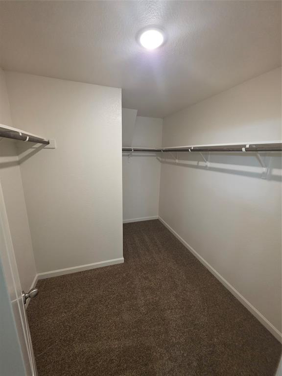 477 Bank Way Crowley, TX 76036 - Photo 15 of 39 Walk in closet with dark colored carpet