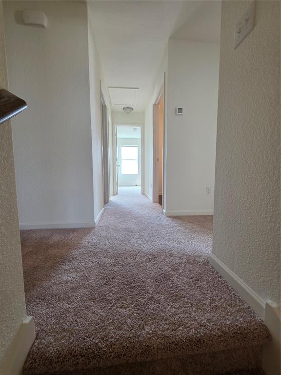 477 Bank Way Crowley, TX 76036 - Photo 19 of 39 Hallway with a textured wall and carpet floors