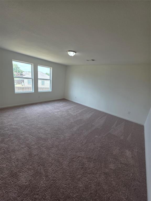 477 Bank Way Crowley, TX 76036 - Photo 28 of 39 Empty room featuring dark colored carpet and baseboards