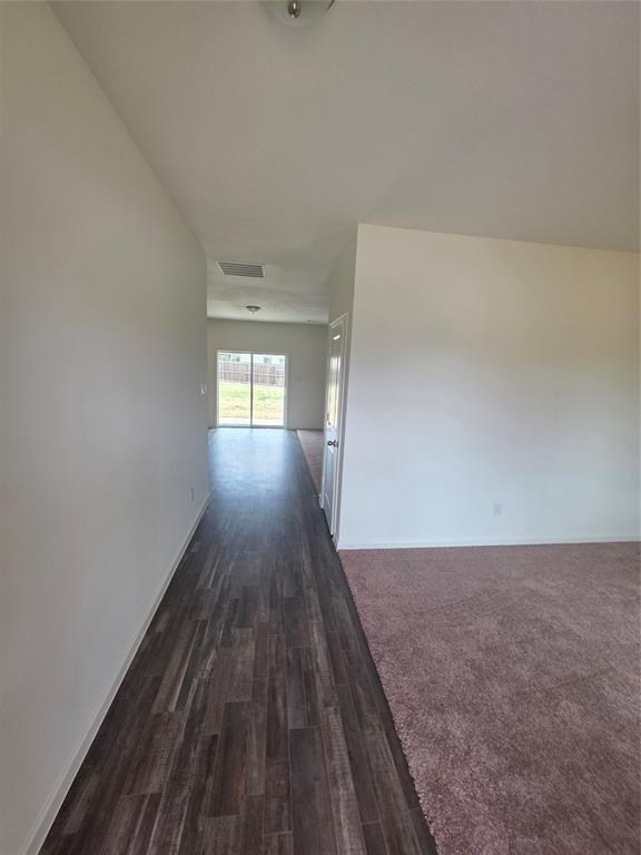 477 Bank Way Crowley, TX 76036 - Photo 31 of 39 Hallway with dark wood-style flooring and baseboards
