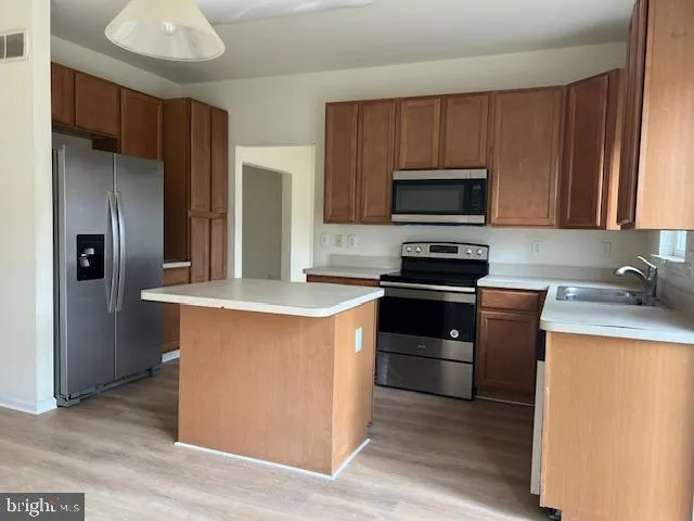 a kitchen with granite countertop a stove and a refrigerator