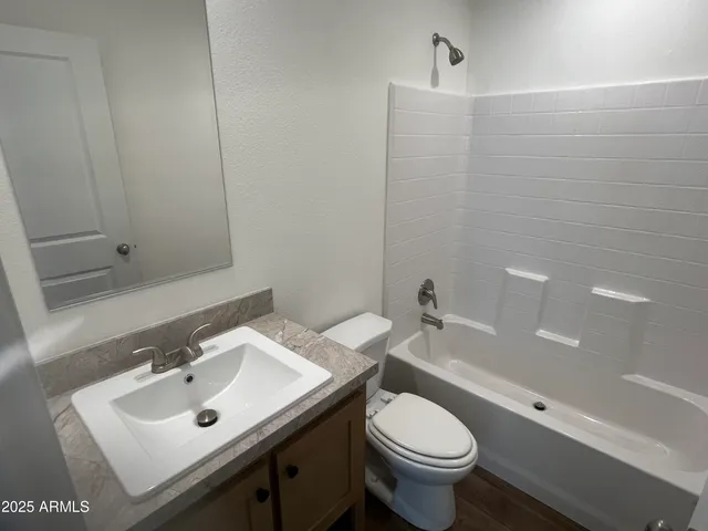 a bathroom with a sink toilet and a mirror