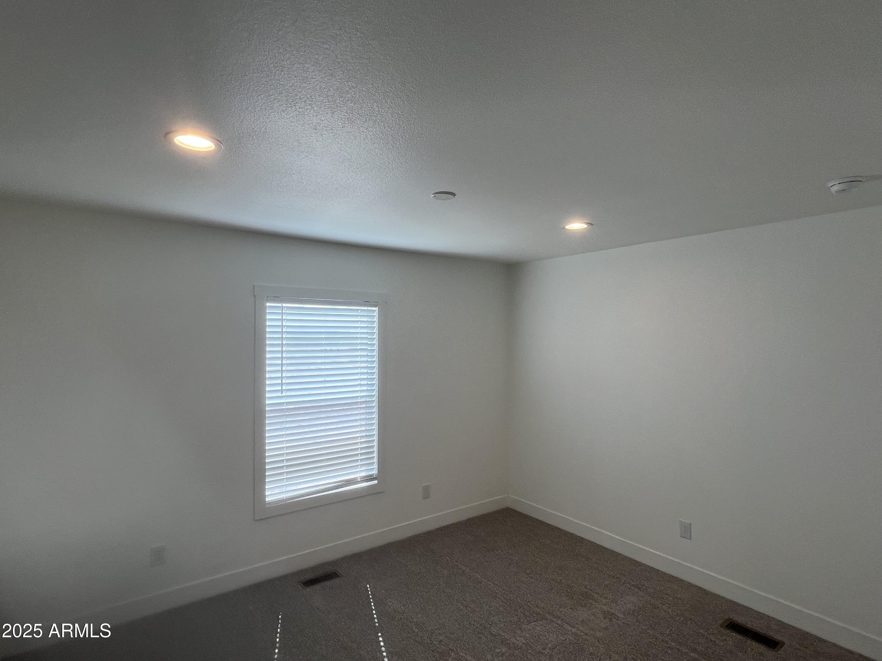 22936 West Forest Pleasant Place, Unit 2 Wittmann, AZ 85361 - Photo 12 of 17 an empty room with a window