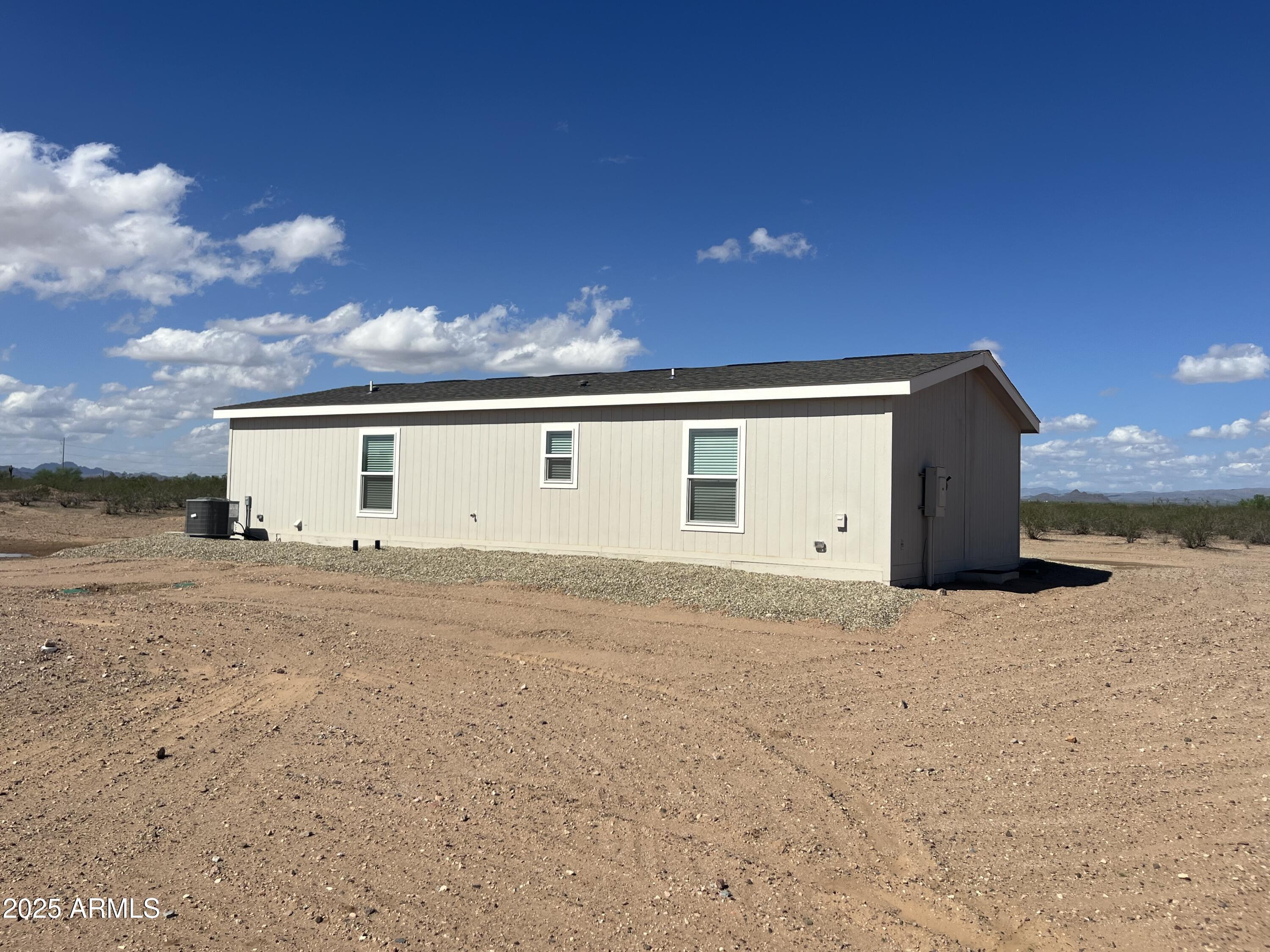 22936 West Forest Pleasant Place, Unit 2 Wittmann, AZ 85361 - Photo 14 of 17 a big house with a big yard and large trees